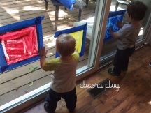 Moose and Roo spread the paint to fill their window bag paintings.